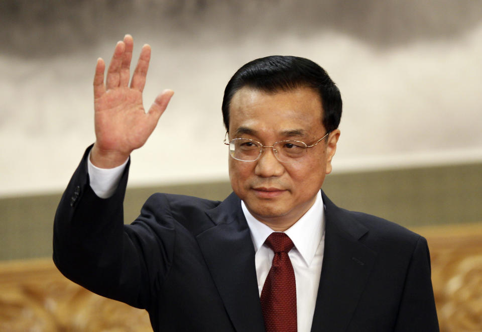 Li Keqiang, one of the seven newly elected member of the Politburo Standing Committee, waves during a press event at Beijing's Great Hall of the People, Thursday Nov. 15, 2012. The seven-member Standing Committee, the inner circle of Chinese political power, was paraded in front of assembled media on the first day following the end of the 18th Communist Party Congress. (AP Photo/Vincent Yu)