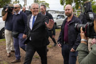 Australian Prime Minister Scott Morrison gestures after voting in his electorate of Cook in Sydney, Australia, Saturday, May 21, 2022. Australians go to the polls Saturday following a six-week election campaign that has focused on pandemic-fueled inflation, climate change and fears of a Chinese military outpost being established less than 1,200 miles off Australia's shore.(AP Photo/Mark Baker)