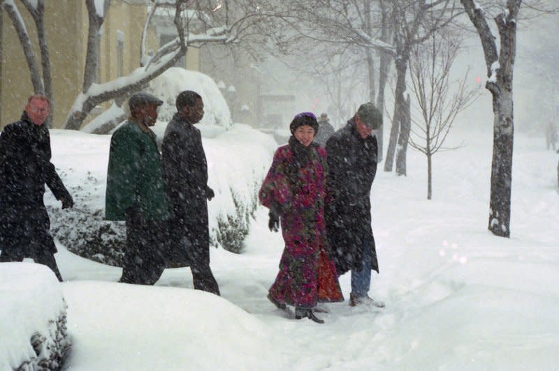 President Bill Clinton and first lady Hillary Rodham Clinton walk back to the White House through a snow storm after attending church at nearby St. John's on Lafayette Square on January 6, 1996. The Blizzard of 1996 began on this day, dropping up to 4 feet of snow and paralyzing Washington, D.C., Baltimore, Philadelphia and other major cities in the Northeast. File Photo by Ken Cedeno/UPI