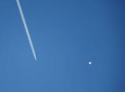 A jet flies by a suspected Chinese spy balloon as it floats off the coast in Surfside Beach