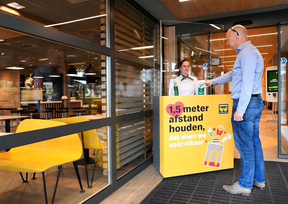 A man takes a number at a prototype location of fast food giant McDonald's for restaurants which respect the 1.5m social distancing measure, amid the coronavirus disease (COVID-19) outbreak, in Arnhem, Netherlands, May 1, 2020. REUTERS/Piroschka van de Wouw