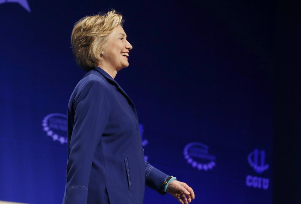 Former Secretary of State Hillary Rodham Clinton smiles as she walks on stage to give an address at a student conference for the Clinton Global Initiative University at Arizona State University, Friday, March 21, 2014, in Tempe, Ariz. (AP Photo/Ross D. Franklin)