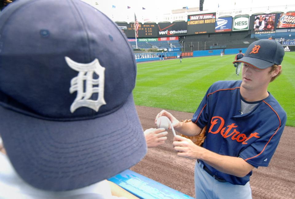 Detroit Tigers' Andrew Miller signs an autograph for a young Tigers' fan prior to the Tigers' game  against the New York Yankees at Yankee Stadium  in New York on Aug. 30, 2006.  Miller was called up from a brief stint at Class-A Lakeland to join the Tigers for their series against fellow division leader New York.