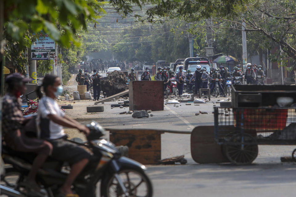 Riot policemen approach a section of the road blocked by anti-coup protesters with debris in Mandalay, Myanmar, Tuesday, March 2, 2021. Demonstrators in Myanmar took to the streets again on Tuesday to protest last month’s seizure of power by the military, as foreign ministers from Southeast Asian countries met to discuss the political crisis. Police in Yangon, Myanmar’s biggest city, used tear gas and rubber bullets against the protesters. (AP Photo)