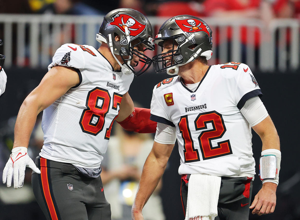 ATLANTA, GEORGIA - DECEMBER 05: (EDITOR'S NOTE: Alternate crop) Rob Gronkowski #87 of the Tampa Bay Buccaneers celebrates his touchdown against the Atlanta Falcons with teammate Tom Brady #12 during the second quarter at Mercedes-Benz Stadium on December 05, 2021 in Atlanta, Georgia. (Photo by Kevin C. Cox/Getty Images)