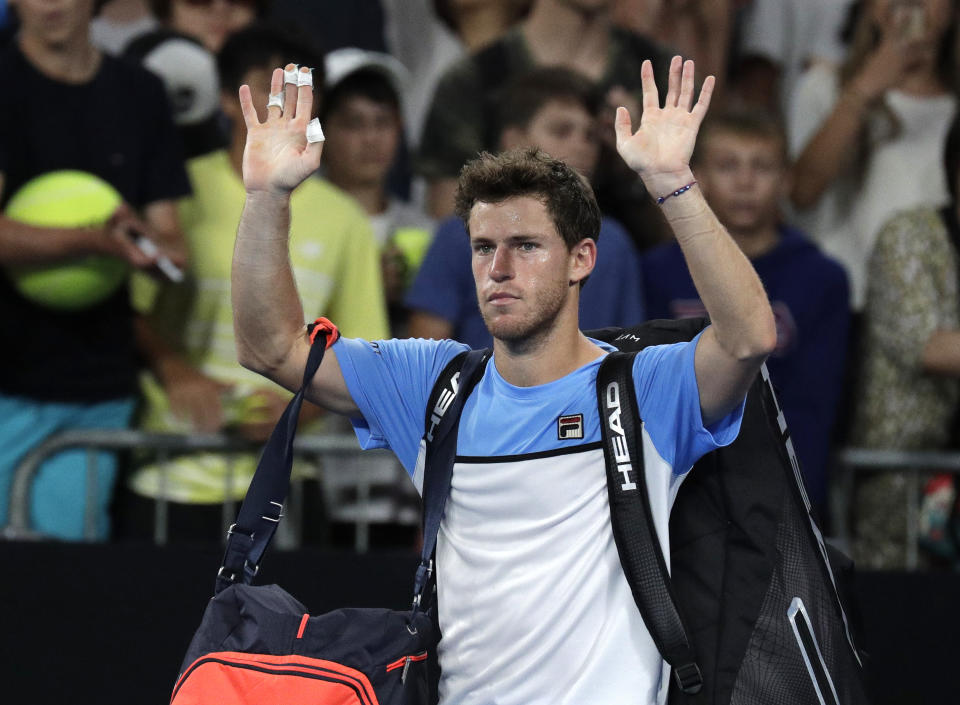 Argentina's Diego Schwartzman waves as he leaves the court following his third round loss to Tomas Berdych of the Czech Republic at the Australian Open tennis championships in Melbourne, Australia, Friday, Jan. 18, 2019. (AP Photo/Aaron Favila)