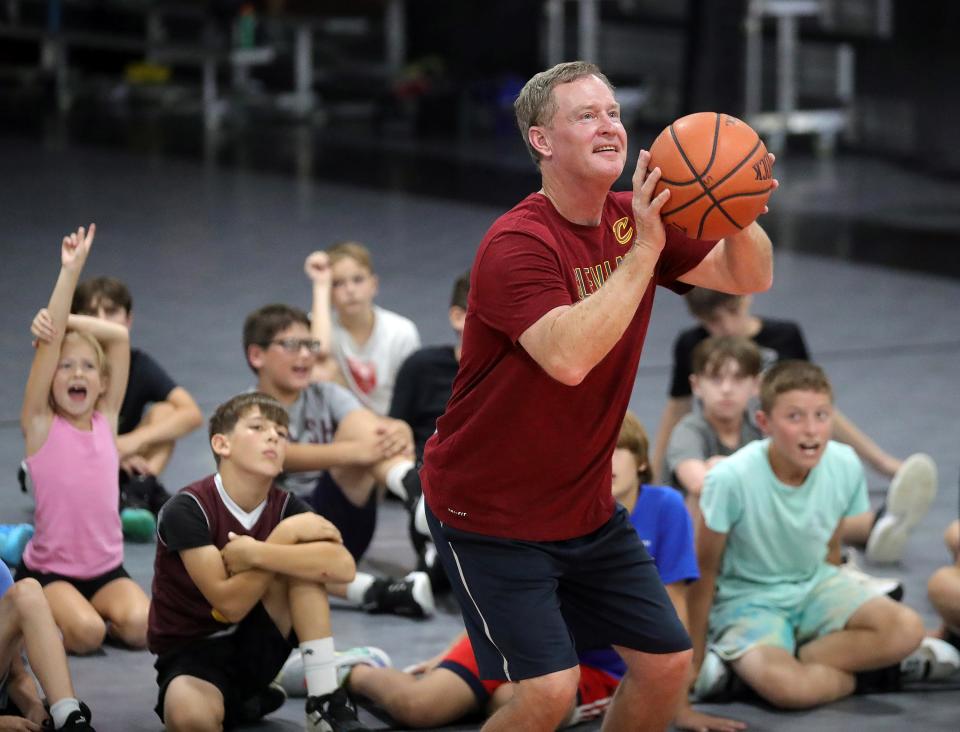 Former Cleveland Cavaliers point guard Mark Price shoots free throws as camp participants cheer during his basketball camp at SWISH 365 Training Center, Wednesday, July 26, 2023, in North Canton, Ohio.