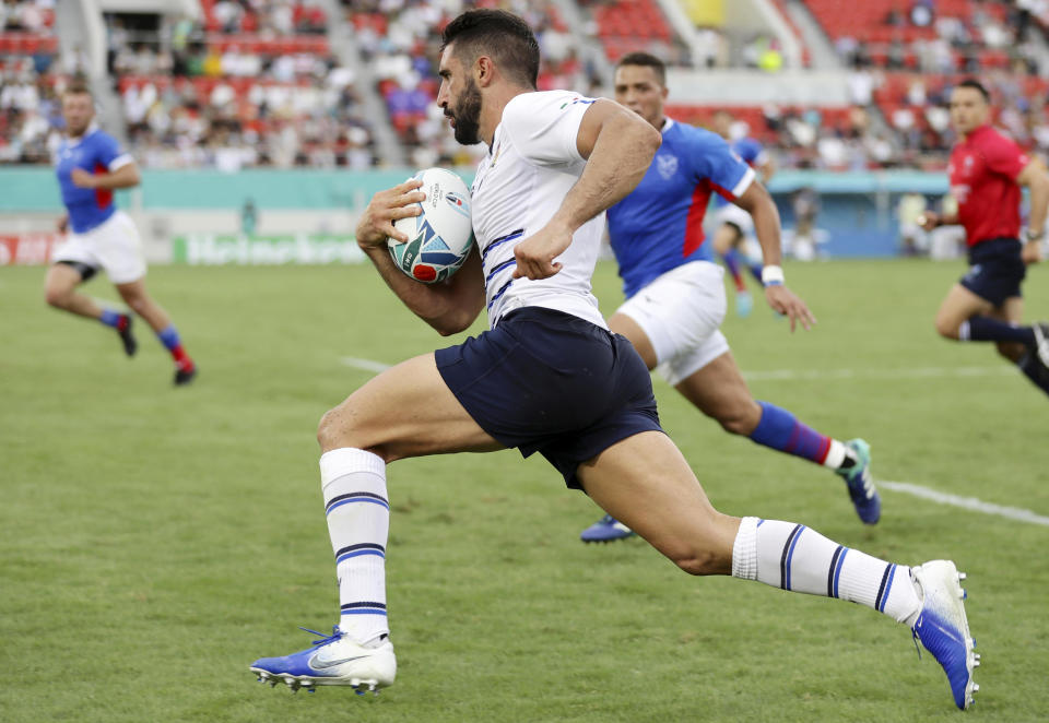 Italy’s Tito Tebaldi runs with the ball to score a try against Namibia during the Rugby World Cup Pool B game between Italy and Namibia in Osaka, western Japan, Sunday, Sept. 22, 2019. (Yohei Fukuyama/Kyodo News via AP)