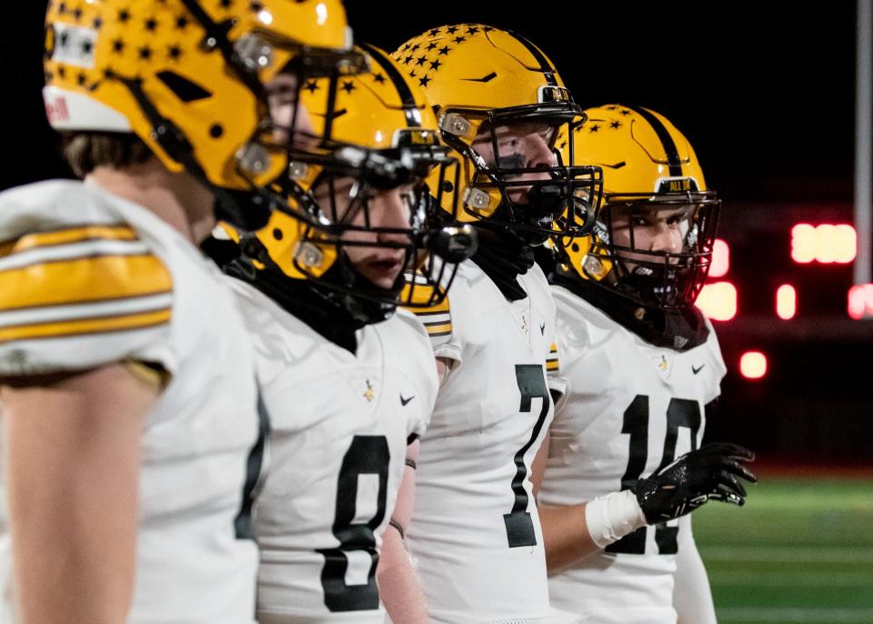 The Central Bucks West captains approach center field for the coin toss before the start of in the PIAA District One Class 6A football championship game against Garnet Valley at Moe DeFrank Stadium in Collegeville on Friday, November 25, 2022. The Jaguars defeated the Bucks 35-7 for the district title.