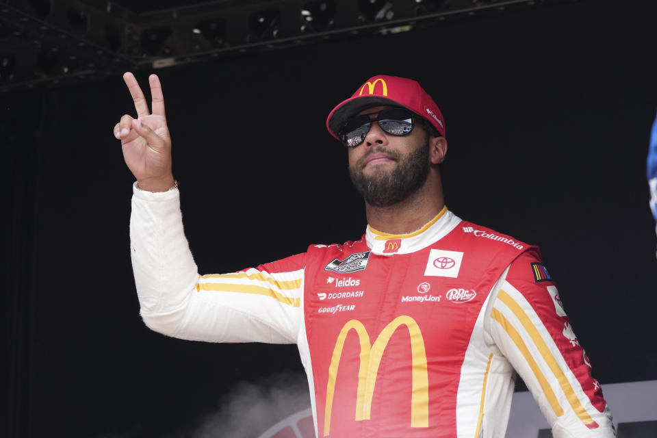 Bubba Wallace gestures after he was introduced before a NASCAR Cup Series auto race at Texas Motor Speedway in Fort Worth, Texas, Sunday, Sept. 24, 2023. (AP Photo/LM Otero)