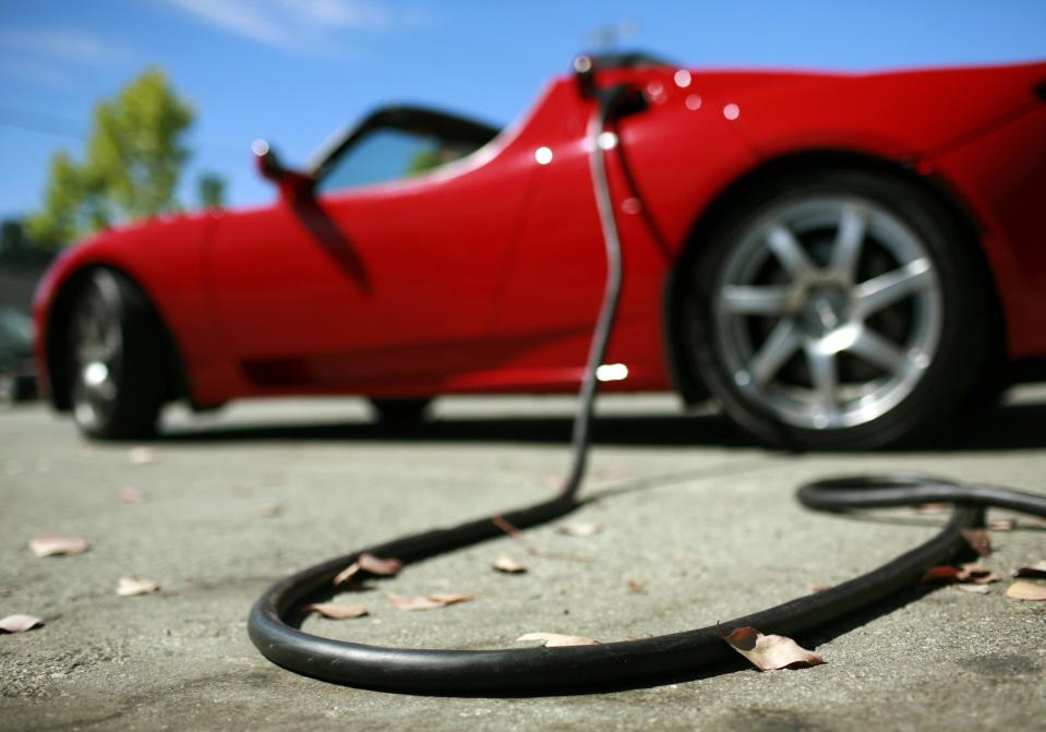 A Tesla Roadster is electrically charged at Tesla Motors Inc in San Carlos, California July 22, 2009. TESLA/ REUTERS/Robert Galbraith