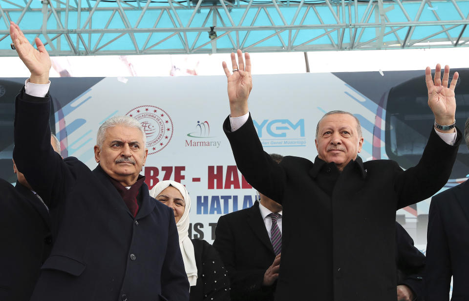 FILE-In this Tuesday, March 12, 2019 file photo, Turkey's President Recep Tayyip Erdogan, right, and Binali Yildirim, the mayoral candidate for Istanbul, salute the supporters of their ruling Justice and Development Party, AKP, during a rally in Istanbul, ahead of local elections scheduled for March 31, 2019. For Erdogan, the local elections are not just a vote to decide who should collect the garbage and maintain roads, they are about Turkey's future national "survival." (Presidential Press Service via AP, Pool)