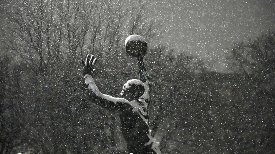 Former Utah Jazz player Karl Malone's bronze statue is shown during a snow storm before an NBA basketball game against the Denver Nuggets Wednesday, Jan. 10, 2024, outside of the Delta Center, in Salt Lake City. (AP Photo/Rick Bowmer)
