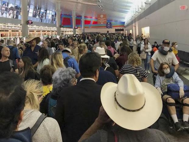 People wait in line to go through the customs at Dallas Fort Worth International Airport in Grapevine, Texas, Saturday, 14 March 2020: AP