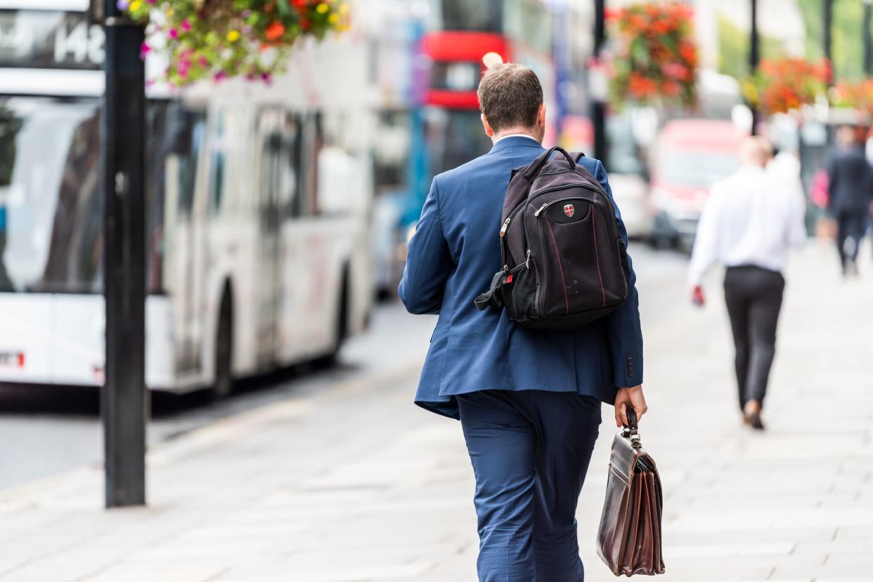 London, UK - September 12, 2018: Neighborhood district of Pimlico Street, businessman man walking with briefcase and backpack before or after work