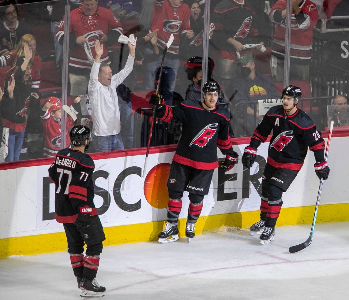 Carolina Hurricanes Tuevo Teravainen (86) celebrates with Tony DeAngelo (77) and Sebastian Aho (20) after scoring on New York Rangers goalie Igor Shesterkin (31) during the second period on Thursday, May 26, 2022 during game five of the Stanley Cup second round at PNC Arena in Raleigh, N.C.