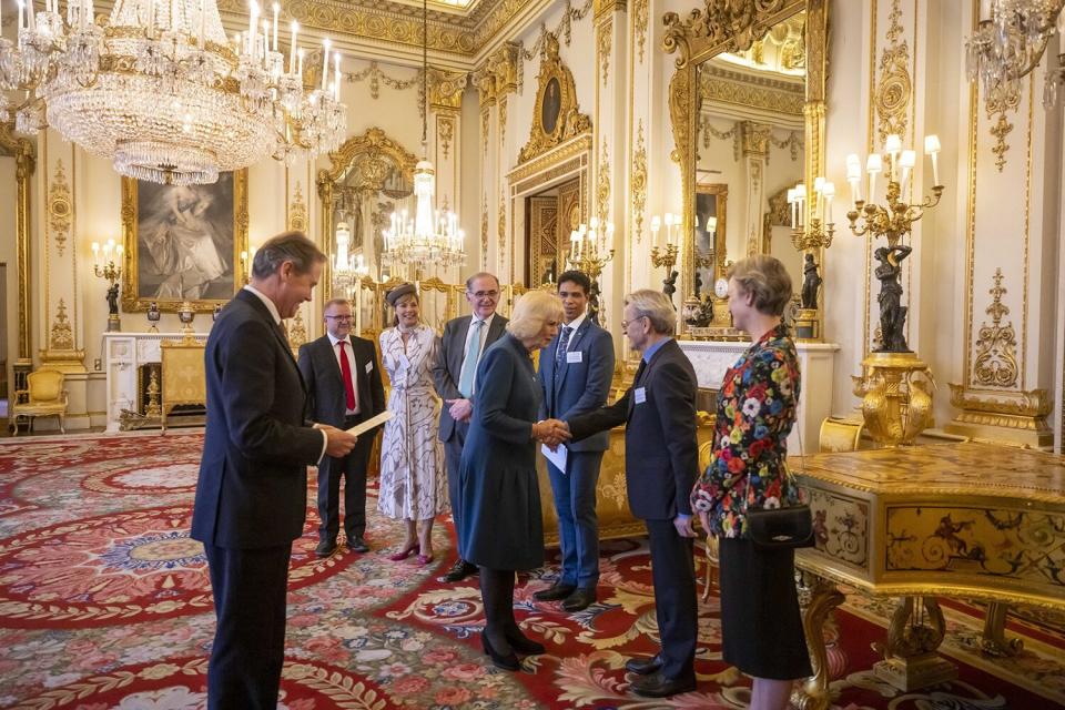 Britain's Camilla, the Queen Consort greets Mikhail Baryshnikov, who received the Royal Academy of Dance's highest honour, the Queen Elizabeth II Coronation Award, in recognition of his contribution to ballet and the wider world of dance, during a ceremony in the White Drawing Room at Buckingham Palace, London