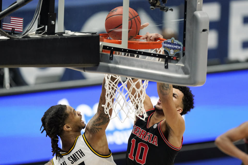 Georgia's Toumani Camara (10) dunks the ball against Missouri's Mitchell Smith in the first half of an NCAA college basketball game in the Southeastern Conference Tournament Thursday, March 11, 2021, in Nashville, Tenn. (AP Photo/Mark Humphrey)