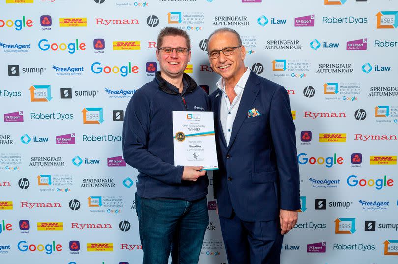 Paul Needler, left, accepting his Small Business Sunday winner's certificate from Theo Paphitis