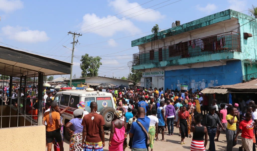 Family members and friends gather outside Redemption Hospital in Monrovia, Liberia, 20 January 2022 (AFP via Getty Images)