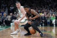 Detroit Pistons' Marcus Sasser, right, loses control of the ball against Boston Celtics' Payton Pritchard (11) during the first half of an NBA basketball game, Monday, March 18, 2024, in Boston. (AP Photo/Michael Dwyer)