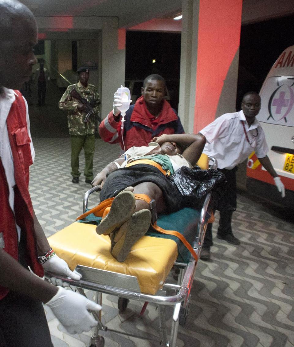 An injured Kenyan is wheeled into Kenyatta National Hospital in Nairobi, Kenya, Monday March 31, 2014, after an explosion in Nairobi killed at least five people. The National Disaster Operation Center said on Twitter that explosions had occurred Monday evening in a neighborhood known for its large Somali population, and the agency said five people were killed and several injured without saying what caused the blasts. (AP Photo/Sayyid Azim)