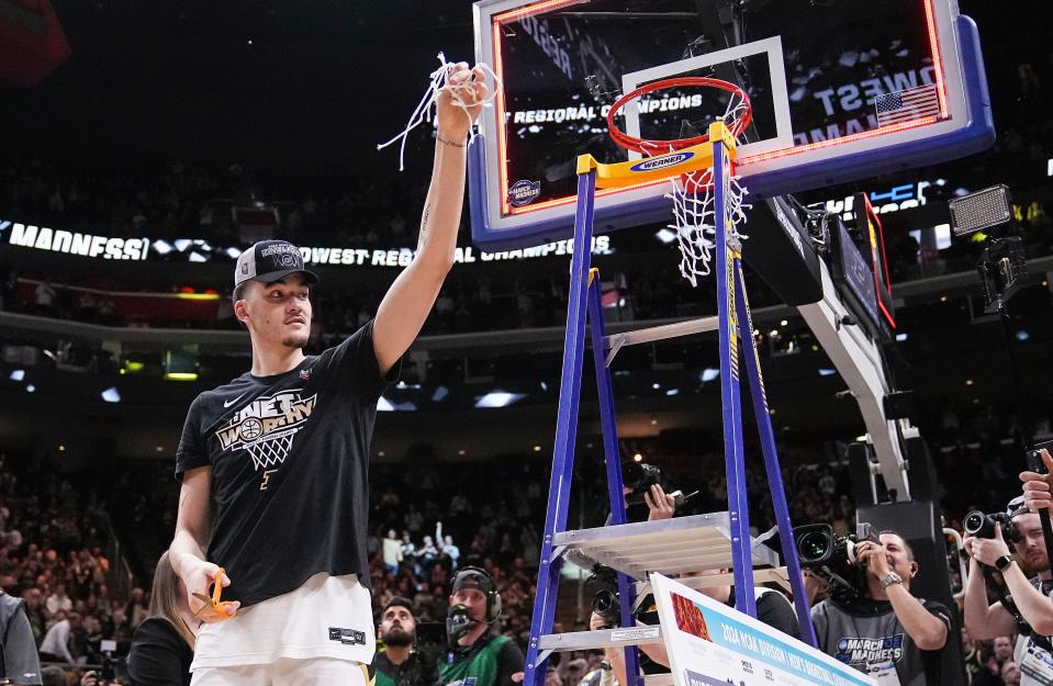 Purdue Boilermakers center Zach Edey (15) holds up a piece of the net Sunday, March 31, 2024, after defeating the Tennessee Volunteers for the midwest regional championship at the Little Caesars Arena in Detroit.