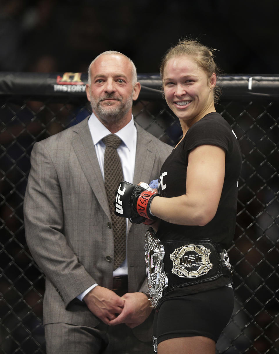 Ronda Rousey, right, smiles with UFC owner Lorenzo Fertitta following her UFC 170 mixed martial arts women's bantamweight title fight against Sara McMann on Saturday, Feb. 22, 2014, in Las Vegas. (AP Photo/Isaac Brekken)