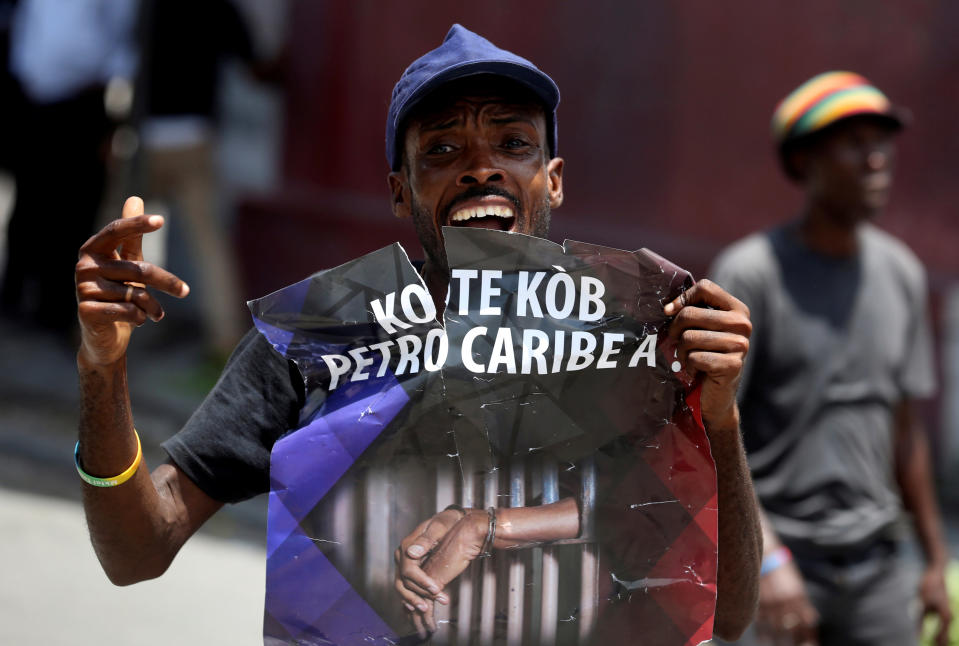 A man holds a poster during a protest