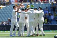 Australia's bowler Pat Cummins (L) celebrates with his teammates after dismissing India's captain Virat Kohli (not pictured) for 3 runs during day one of the first test match between Australia and India at the Adelaide Oval in Adelaide, Australia, December 6, 2018. AAP/Dave Hunt via REUTERS
