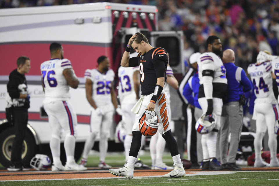 Cincinnati Bengals quarterback Joe Burrow (9) pauses as Buffalo Bills' Damar Hamlin is examined by medical staff during the first half of an NFL football game, Monday, Jan. 2, 2023, in Cincinnati. (AP Photo/Emilee Chinn)