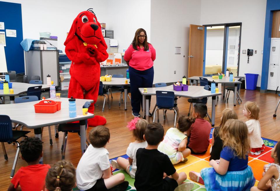 In May, Superintendent Grenita Lathan helped pass out bags of books to the district's youngest learners. Clifford the Big Red Dog visited schools this summer to encourage reading.