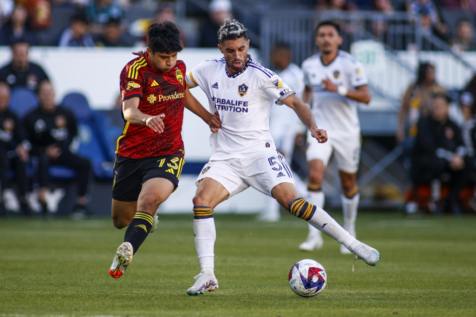 CORRECTS SOUNDERS PLAYER TO OBED VARGAS, INSTEAD OF JORDAN MORRIS - Seattle Sounders midfielder Obed Vargas (73) and LA Galaxy midfielder Gaston Brugman (5) vie for the ball during the second half of an MLS soccer match in Carson, Calif., Saturday, April1, 2023. (AP Photo/Ringo H.W. Chiu)