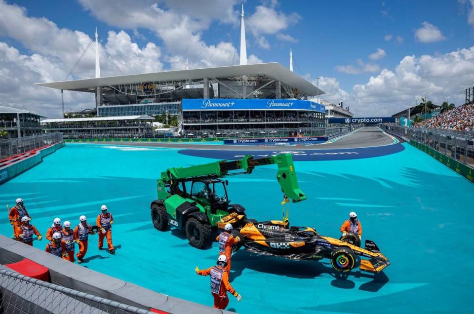 McLaren driver Lando Norris’ car is towed off the track by intervention marshals after he crashed during the Sprint race on the second day of the Formula One Miami Grand Prix.