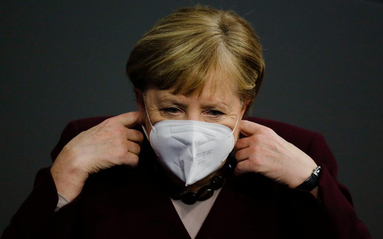 German Chancellor Angela Merkel adjusts her face mask as she arrives for a parliament session about German government's policies to combat the spread of the coronavirus and COVID-19 disease at the parliament Bundestag, in Berlin, Germany - Markus Schreiber