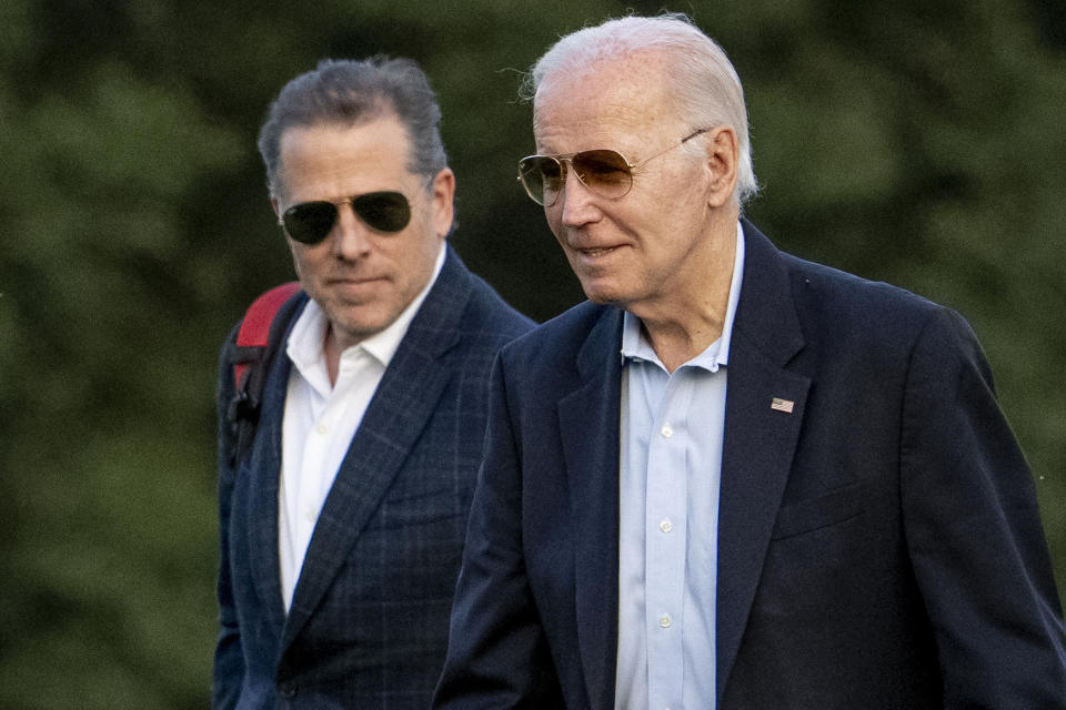 President Biden with his son Hunter, both wearing sunglasses with open shirt collars and sport jackets.