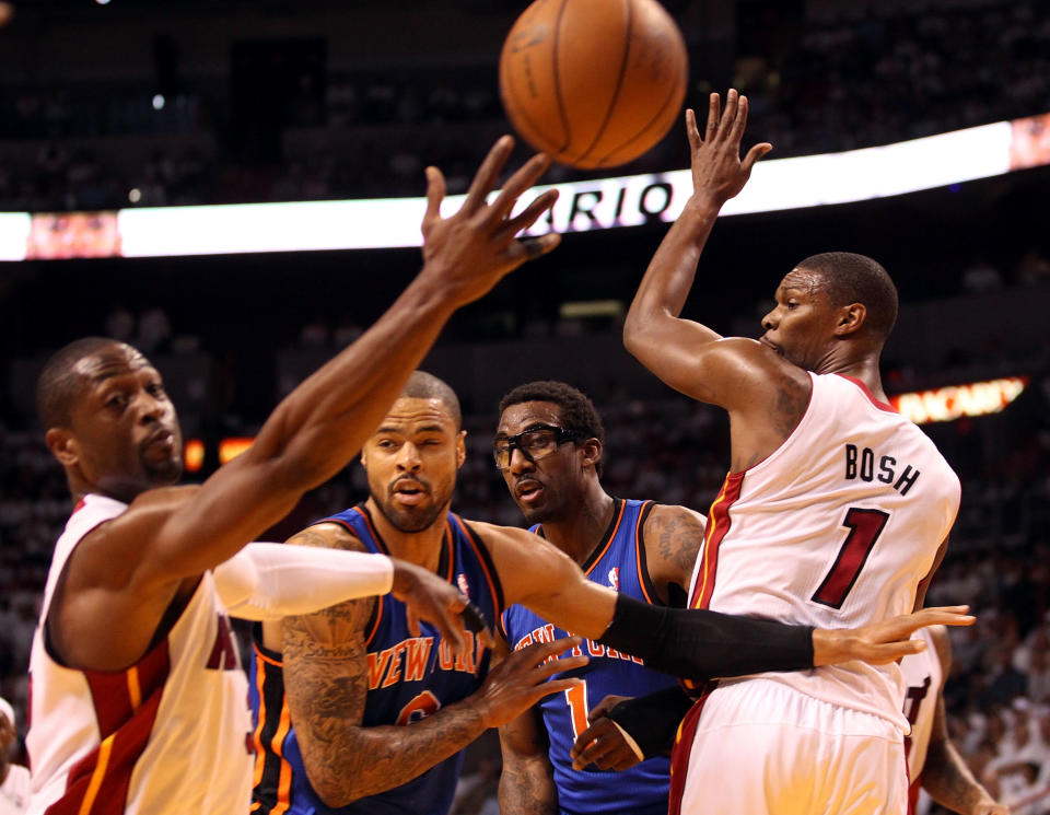 MIAMI, FL - MAY 09: Forward Chris Bosh #1 (R) and Guard Dwyane Wade #3 (L) of the Miami Heat defend against Tyson Chandler and Amar'e Stoudemire of the New York Knicks in Game Five of the Eastern Conference Quarterfinals in the 2012 NBA Playoffs on May 9, 2012 at the American Airines Arena in Miami, Florida. Miami defeated the Knicks 106-94 to advance to the next round four games to one. NOTE TO USER: User expressly acknowledges and agrees that, by downloading and or using this photograph, User is consenting to the terms and conditions of the Getty Images License Agreement. (Photo by Marc Serota/Getty Images)