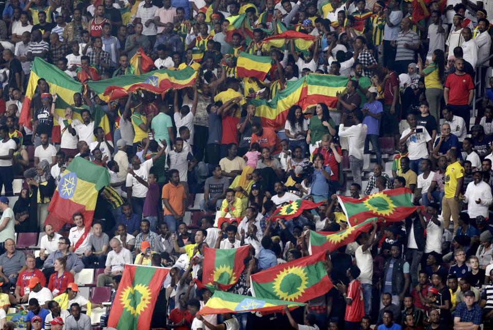Spectators wave Ethiopian flags, top, and flags of the Oromo Liberation Front, bottom, at the World Athletics Championships in Doha, Qatar, Monday, Sept. 30, 2019. (AP Photo/Petr David Josek)