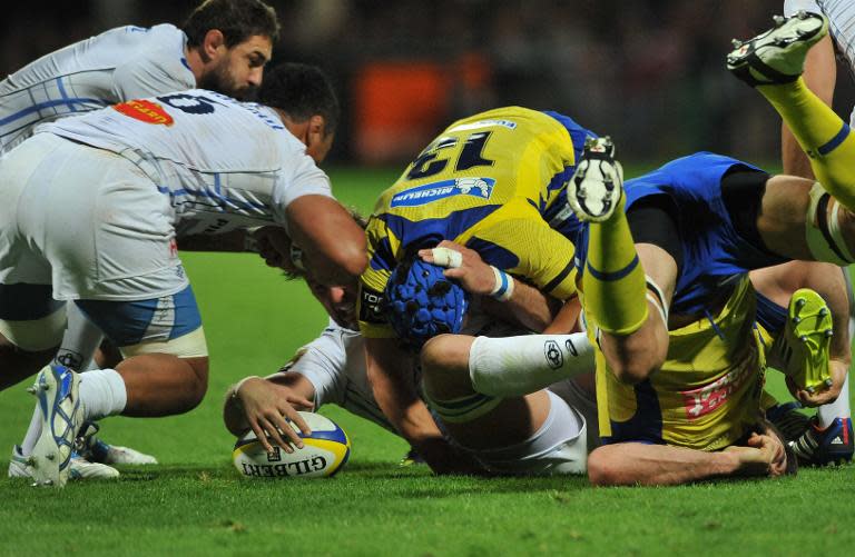 Castres forward Antonie Claassen passes the ball after being tackled during a match against Clermont at the Michelin stadium in Clermont-Ferrand, France, on April 11, 2014