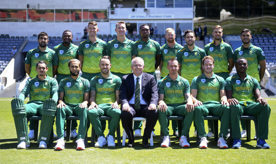 Australian Prime Minister Scott Morrison, bottom center, poses for photographs with the South African cricket team ahead of the limited overs match between the Prime Minister's XI and South Africa in Canberra, Wednesday, Oct. 31, 2018. (Lukas Coch/AAP Image via AP)