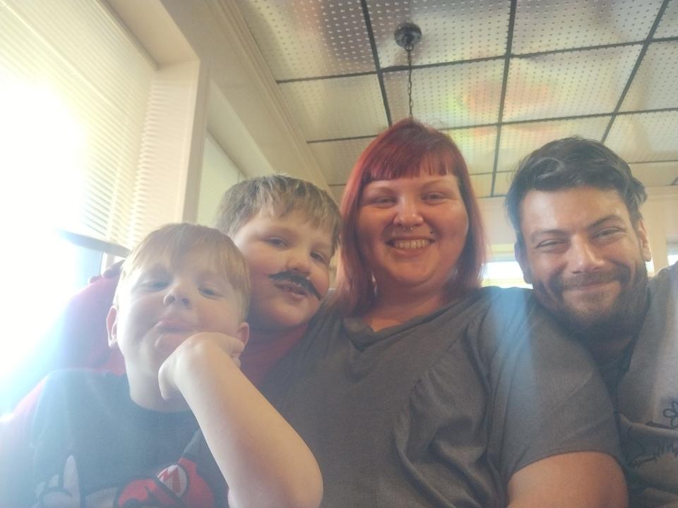 Emily-Sue Snyder poses for a family photo with her children, Elliott McDonald, 4, Connor McDonald, 6, and her fiancé, Chayne Easky.
