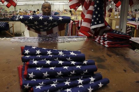 Sandra Evans inspects U.S. flags at Valley Forge's manufacturing facility in Lane, South Carolina June 23, 2015. REUTERS/Brian Snyder