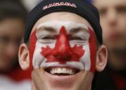 A Canadian supporter cheers before Canada plays the United States in their IIHF World Junior Championship ice hockey game in Malmo, Sweden, December 31, 2013. REUTERS/Alexander Demianchuk (SWEDEN - Tags: SPORT ICE HOCKEY)