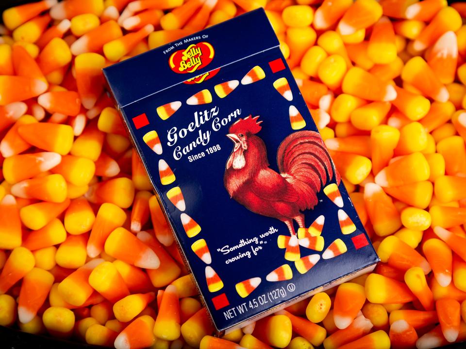 A box of Goelitz recipe candy corn in a bed of Brach's candy corn. Brach's is the market leader.