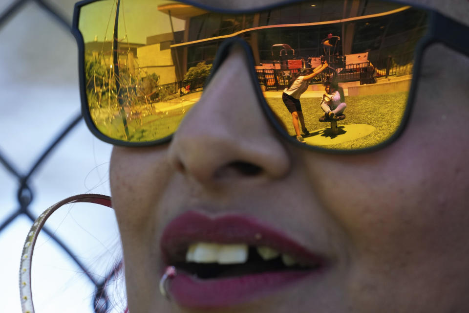 Teniah Tercero watches as her daughters play at a park playground Thursday, May 23, 2024, in San Francisco. (AP Photo/Godofredo A. Vásquez)