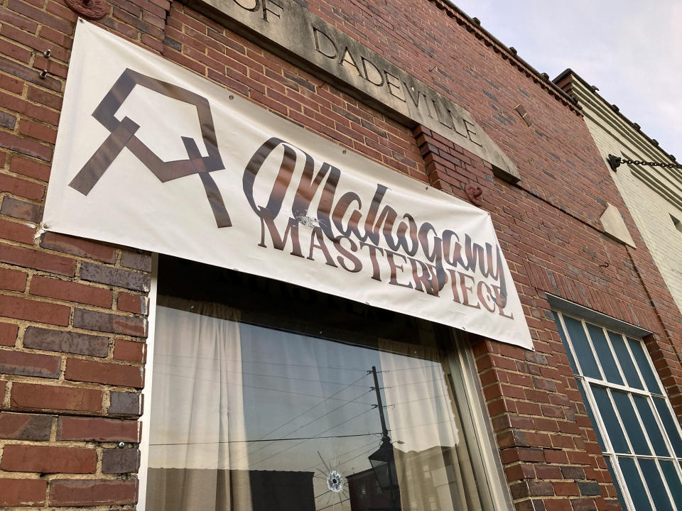 A bullet hole is visible in the glass transom over the door at the Mahogany Masterpiece dance studio in Dadeville, Ala., on Sunday, April 16, 2023. Several people were killed and multiple others injured in a shooting at a birthday party at the dance studio the previous night. (AP Photo/Jeff Amy)