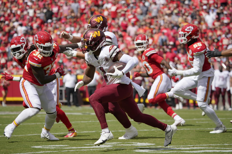 Washington Commanders wide receiver Jahan Dotson (1) runs with the ball as Kansas City Chiefs linebacker Nick Bolton (32) defends during the first half of an NFL preseason football game Saturday, Aug. 20, 2022, in Kansas City, Mo. (AP Photo/Ed Zurga)