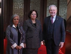 Sen. Rosemary Moodie (centre) poses for a photograph with Sen. Ratna Omidvar and Sen. Peter Harder outside the Senate Chamber.