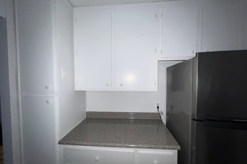 Basic white apartment kitchen before peel and stick renovation.