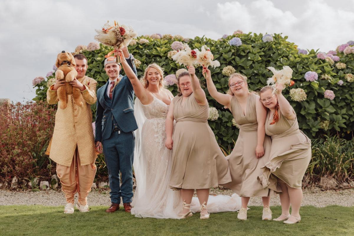 Kayrin and her new husband Alex with their delighted 'flowermaids' <i>(Image: Sadie Jill Photography/SWNS)</i>